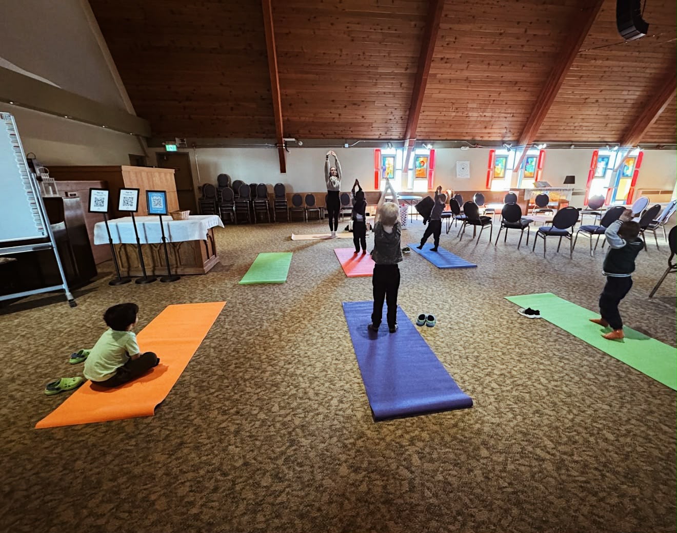 Children practicing yoga together at a community event